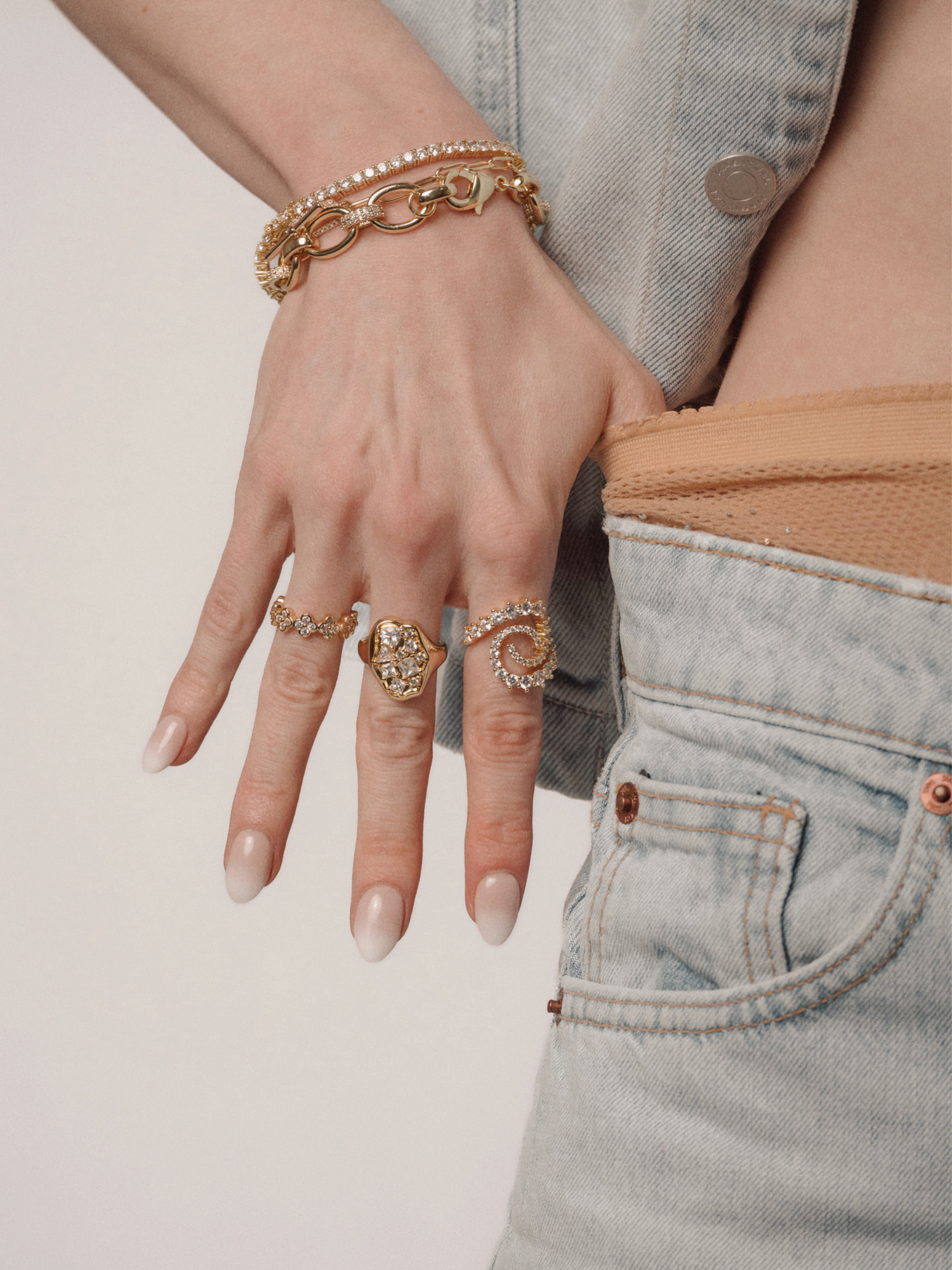 woman wearing lace gloves with gold rings underneath