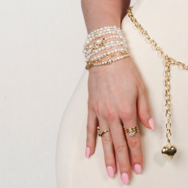 woman wearing lace gloves and gold bracelets